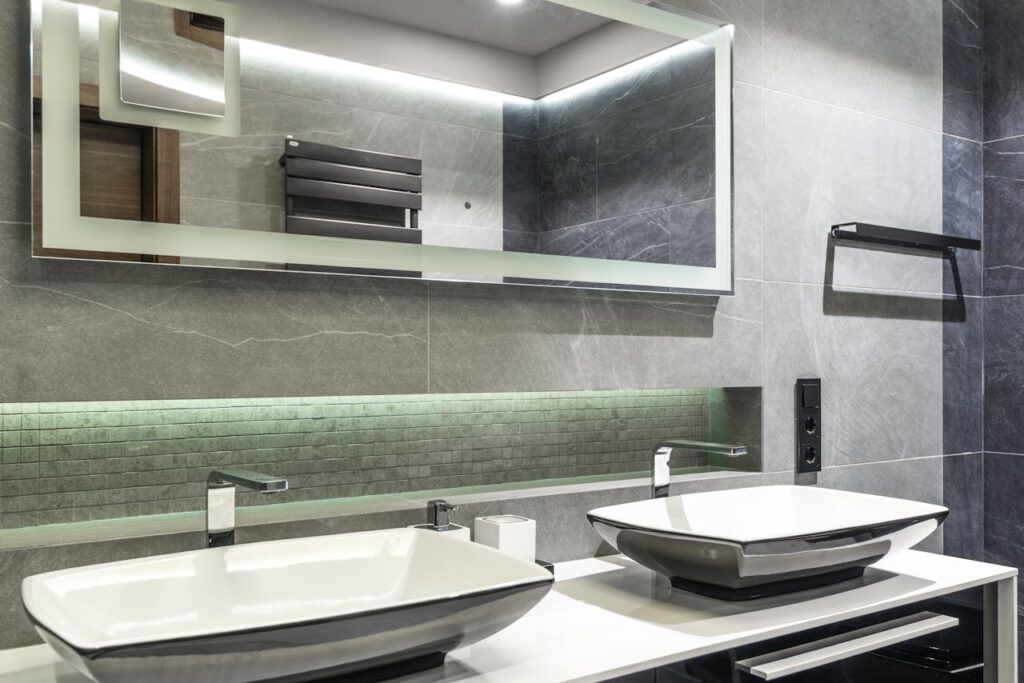 Stylish double sink bathroom with a sleek mirror and contemporary design.